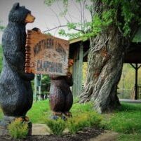 Wooden bear sculptures holding &#039;Northern California&#039; sign.